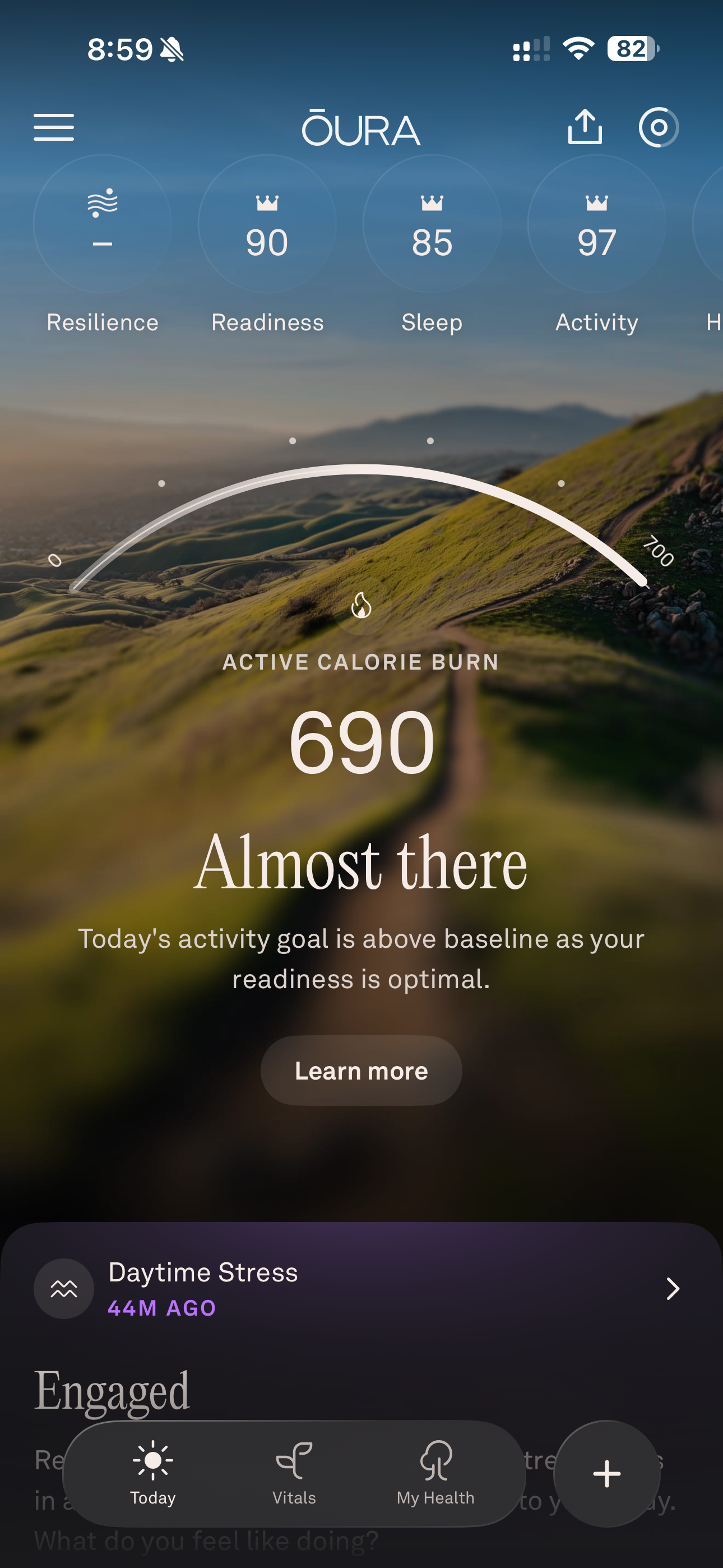 A digital dashboard displays health metrics including readiness, sleep, and activity scores along with a current active calorie burn reading of 690, suggesting nearing a daily goal.
